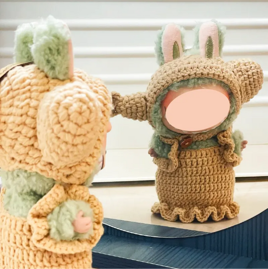 Handmade crochet doll wearing a beige bunny costume with ears and ruffled edges by The Knit Krazy