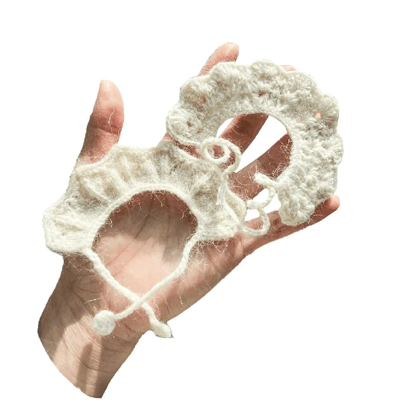 White lace glove held in a hand on a white background