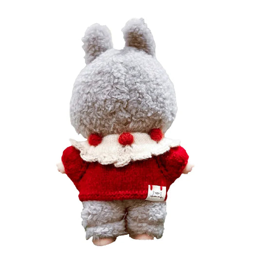 Plush toy with a red sweater and white fluffy trim on a white background
