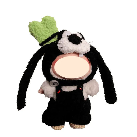 Plush toy resembling a black and white character with a green hat on a white background