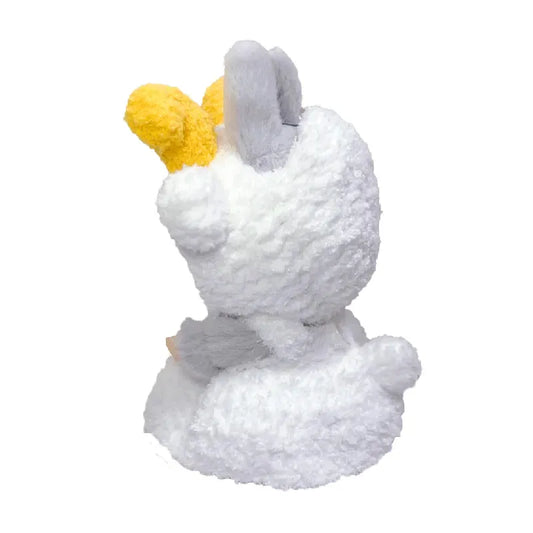 White plush toy with a yellow bow on a white background
