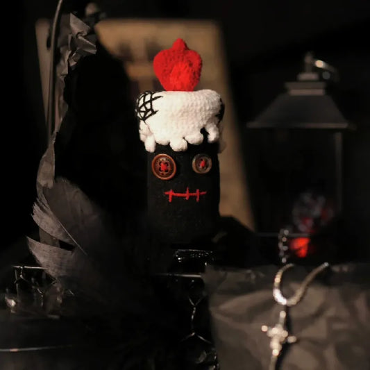 Decorative item resembling a cake with a red top on a dark background