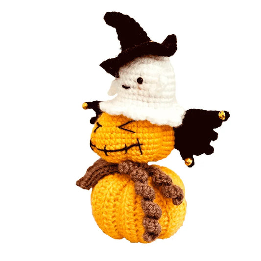 Crocheted Halloween-themed figure with a pumpkin body, ghost head, and witch hat on a white background.