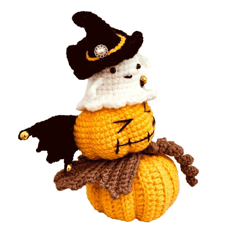 Crocheted scarecrow with a pumpkin body on a white background