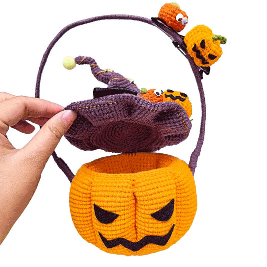 Handmade Halloween-themed basket with pumpkins and a witch hat on a white background