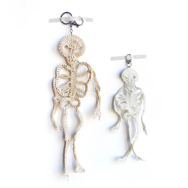 Skeletal design earrings on a white background