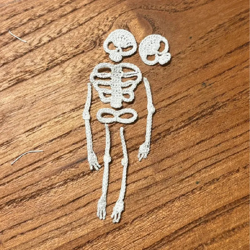 White skeleton drawing on a wooden surface