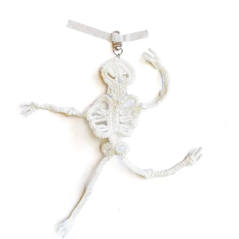 White macramé wall hanging on a white background