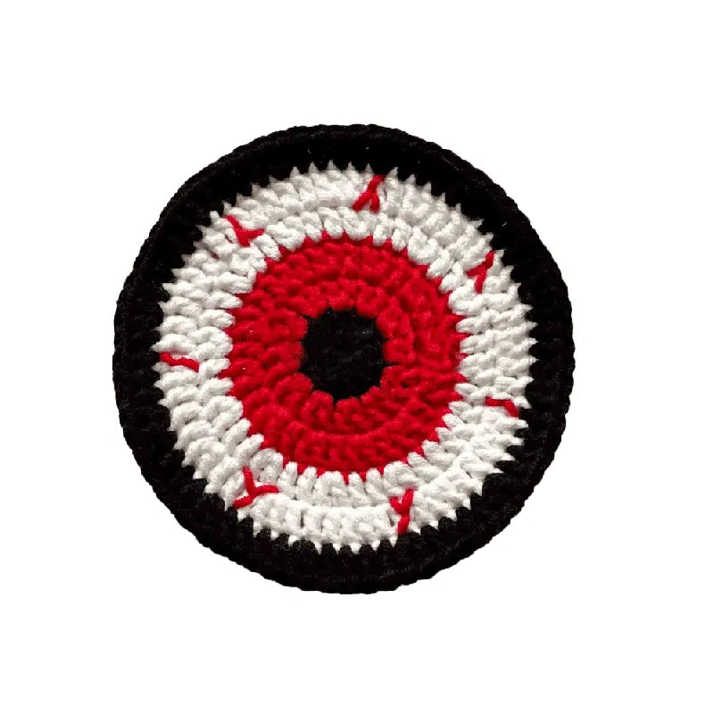 Circular patch with an eye design featuring red, white, and black on a white background