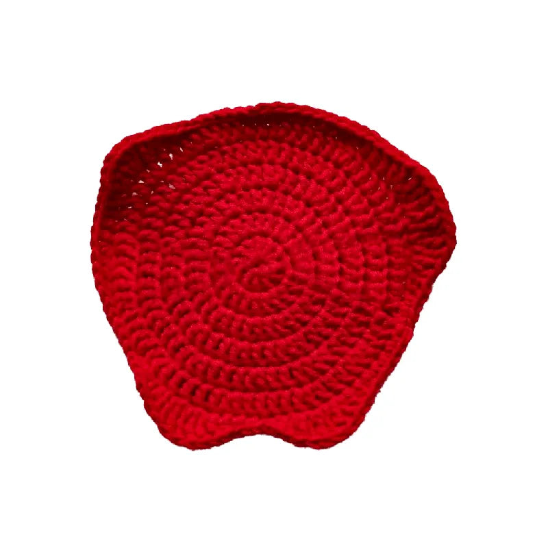 Red knitted coaster on a white background