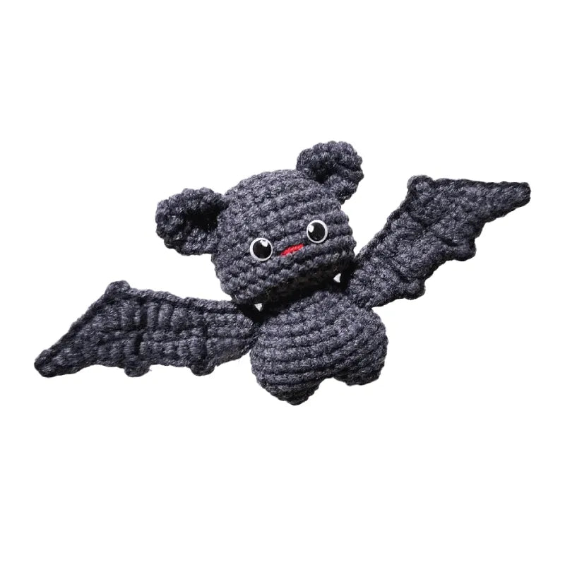 Crocheted bat toy on a white background