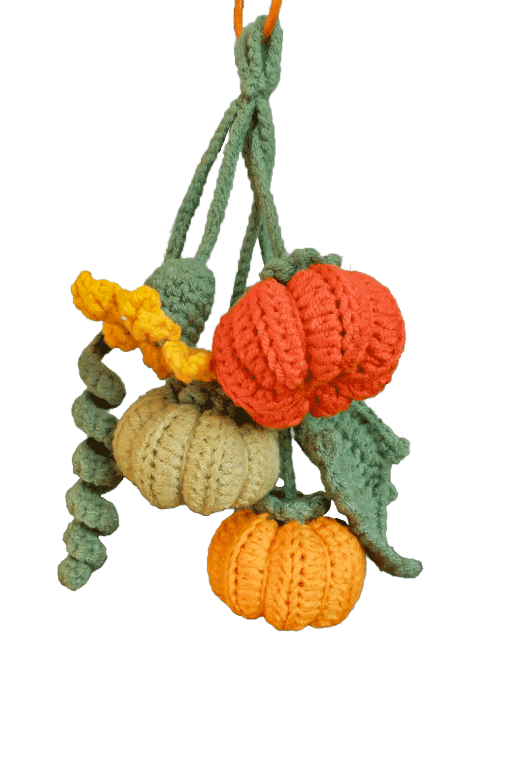 Crocheted pumpkins and leaves on a white background