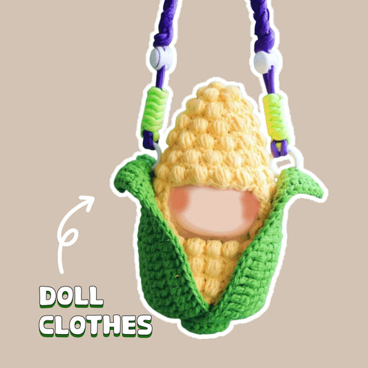 Amigurumi doll crochet kit featuring a handmade corn doll with green husk clothes hanging on purple string