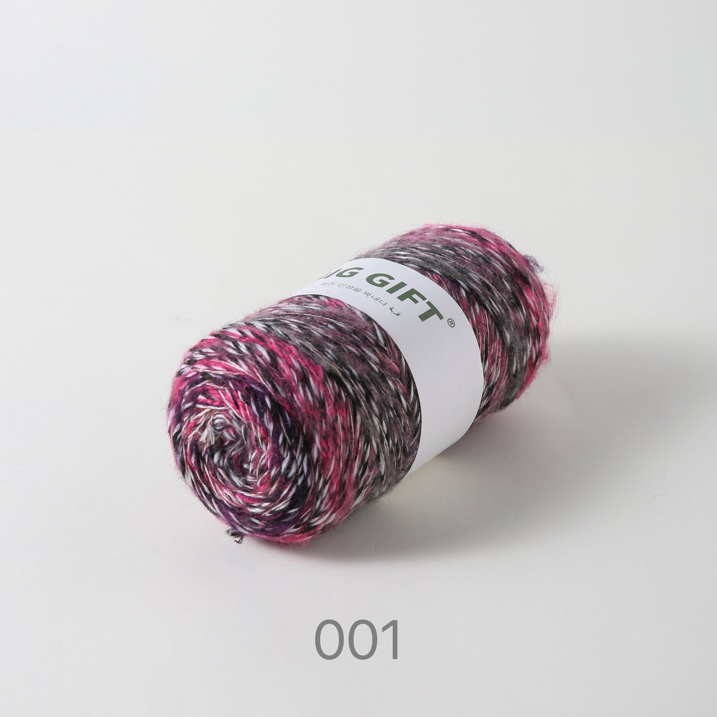 Artisan wool blend for crochet in a multi-color yarn skein with shades of pink black and white