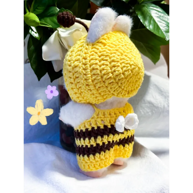 Handmade bee crochet doll dressed in yellow and black striped bee crochet doll clothes pattern with wings and antennae