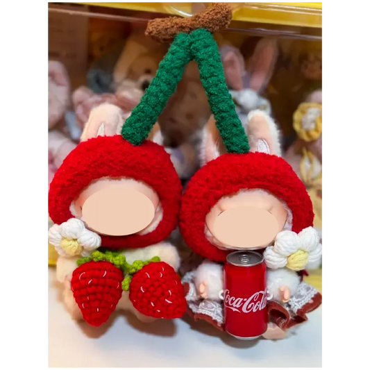 Cherry-themed crochet outfit for plushies featuring red cherry hats and decorative white flowers
