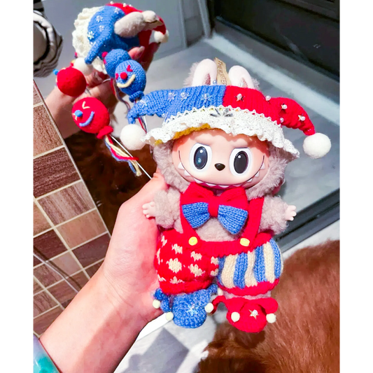 Hand holding a colorful handmade Circus Clown Crochet Pattern doll with a red and blue jester hat