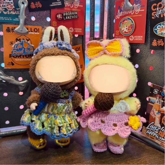 Two handmade collectible crochet doll patterns dressed in colorful outfits holding crocheted microphones