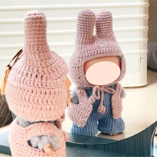 Handmade pink crochet bunny hat and vest on a small doll reflected in a mirror by The Knit Krazy