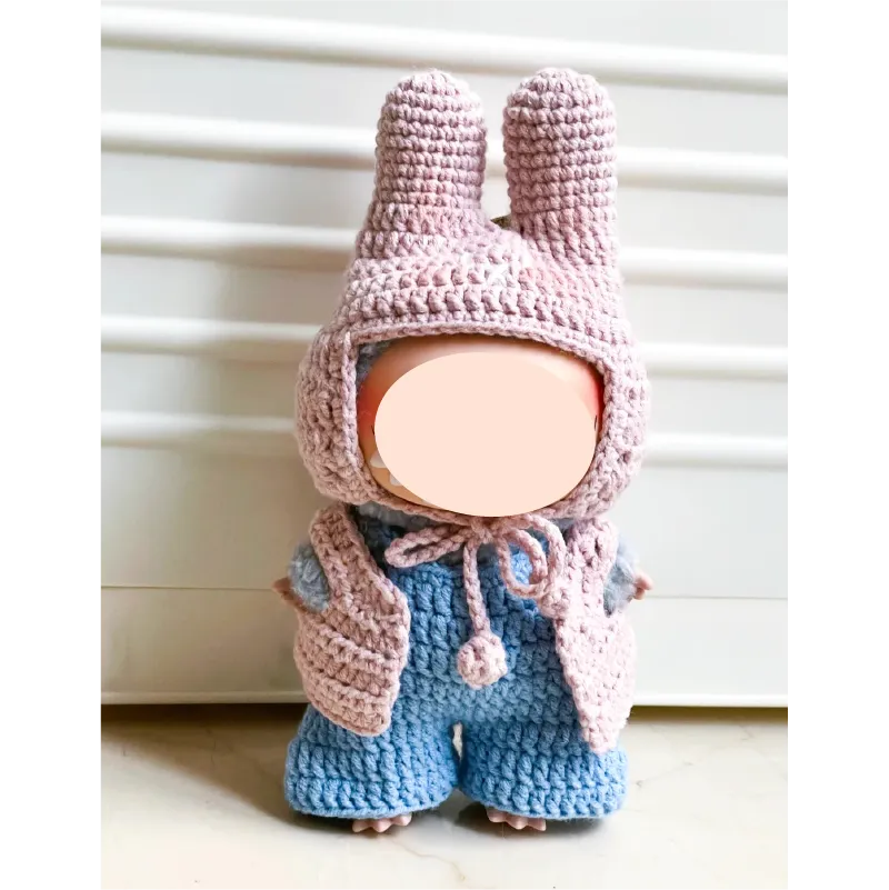Handmade crochet doll wearing pink bunny ear hat and vest with blue pants from The Knit Krazy