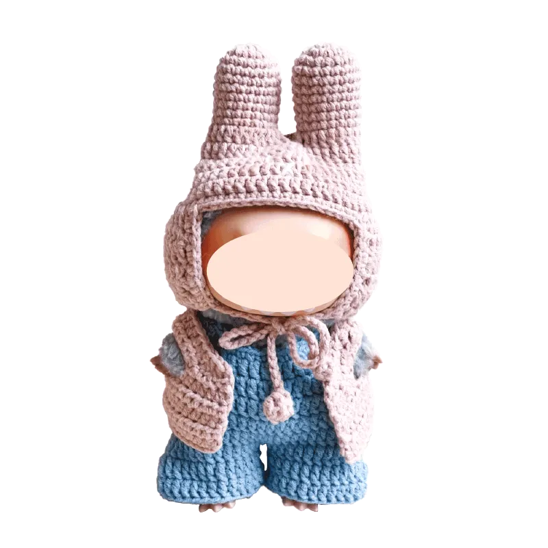 Handmade crochet baby doll wearing pink bunny hat and blue overalls by The Knit Krazy