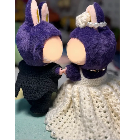 Purple bunny couple holding hands with crochet doll wedding pattern featuring a white crocheted dress and black suit