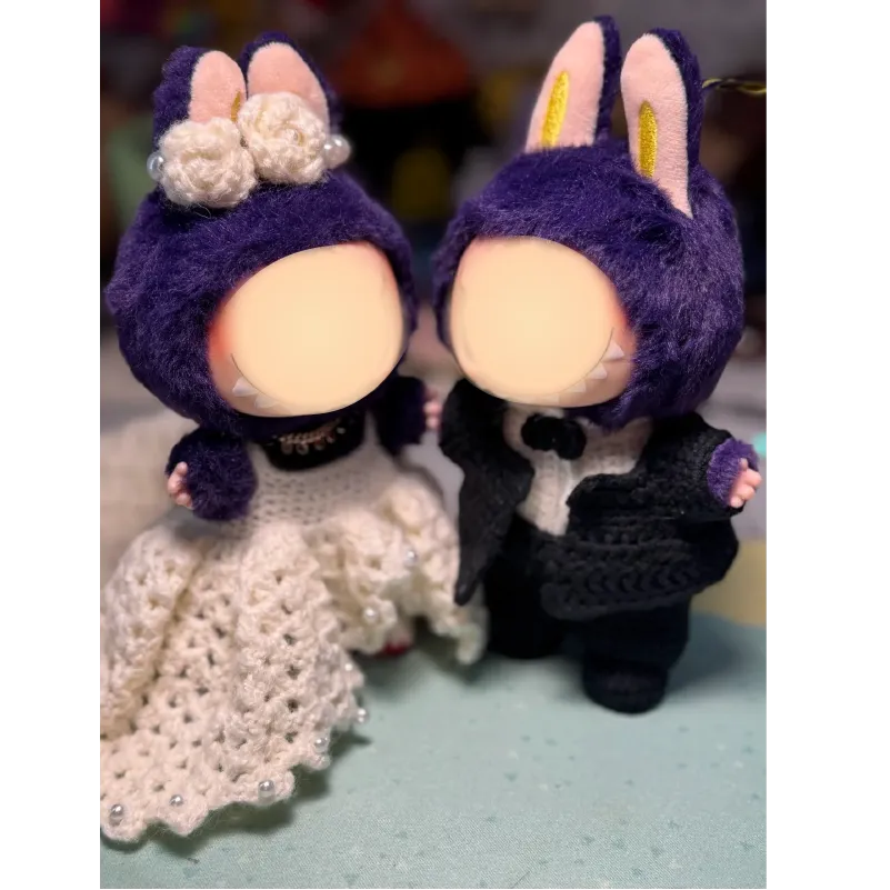 Handmade crochet doll wedding pattern featuring bride and groom dolls with purple bunny ears and detailed outfits