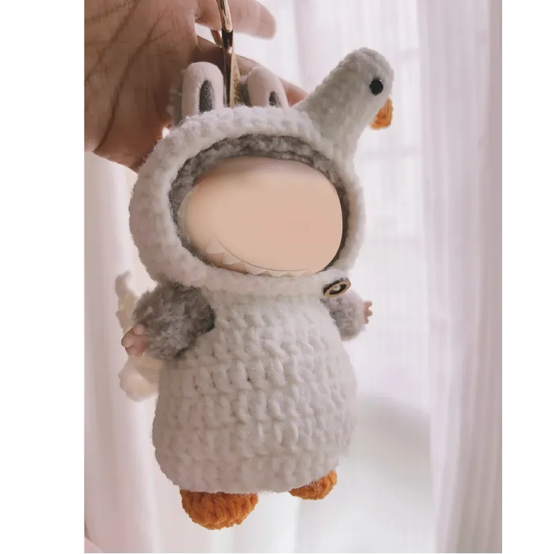 Handmade crochet goose outfit pattern keychain with soft textured yarn in white and orange