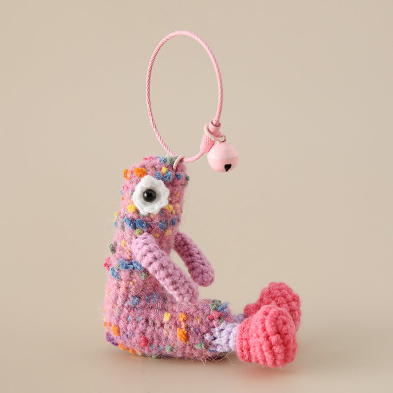 Colorful crochet letter L pendant with floral details and pink bell on a loop keychain