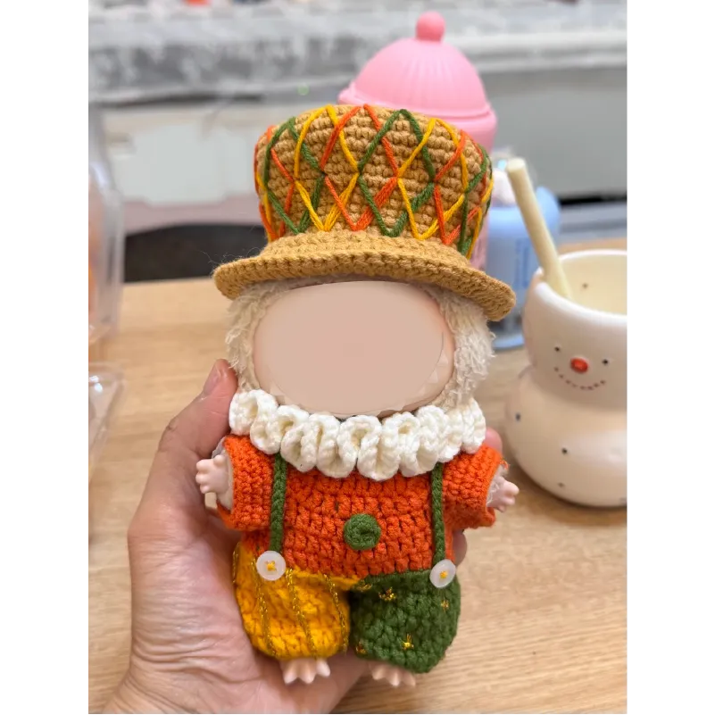 Hand holding a crochet doll dressed in colorful clothes and hat using crochet little duke outfit pattern