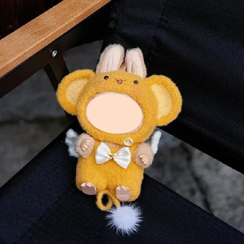 Cute yellow crochet monkey outfit pattern with bunny ears and white pompom tail on black fabric