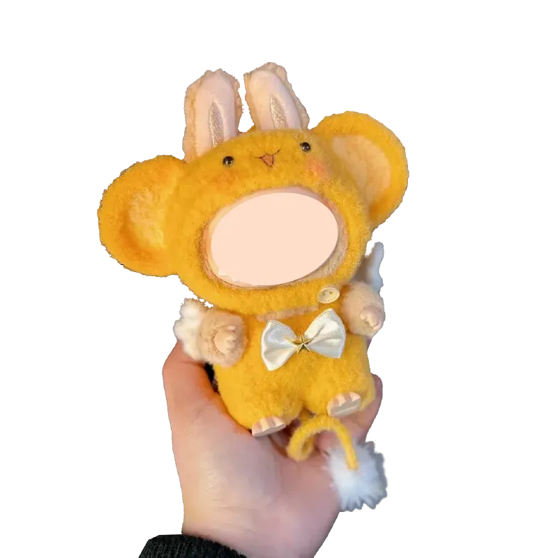 Hand holding a yellow plush toy wearing a crochet monkey outfit pattern with bunny ears and white bow