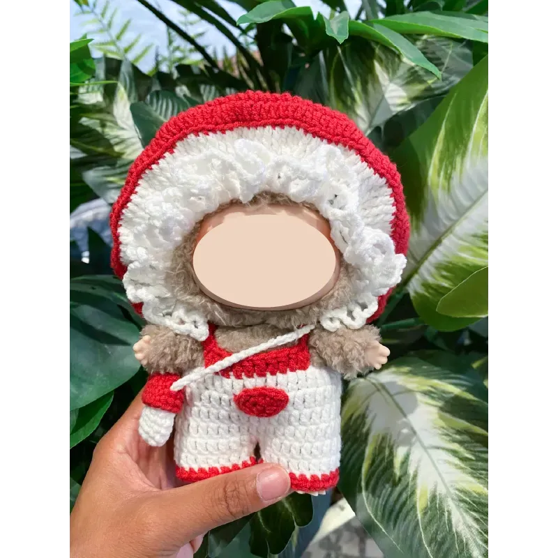Hand holding a crocheted doll wearing a red and white mushroom hat using Crochet Mushroom Doll Pattern