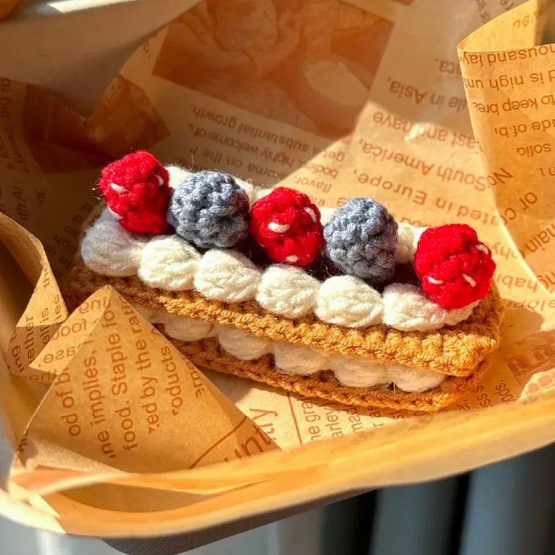 Crochet Napoleon cake pattern with realistic layers and colorful crocheted berries on top