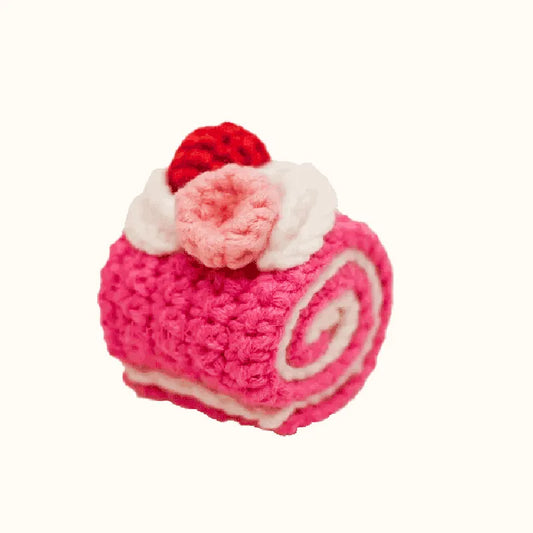 Handcrafted crochet raspberry swiss roll pattern with pink swirls and decorative cream and red accents