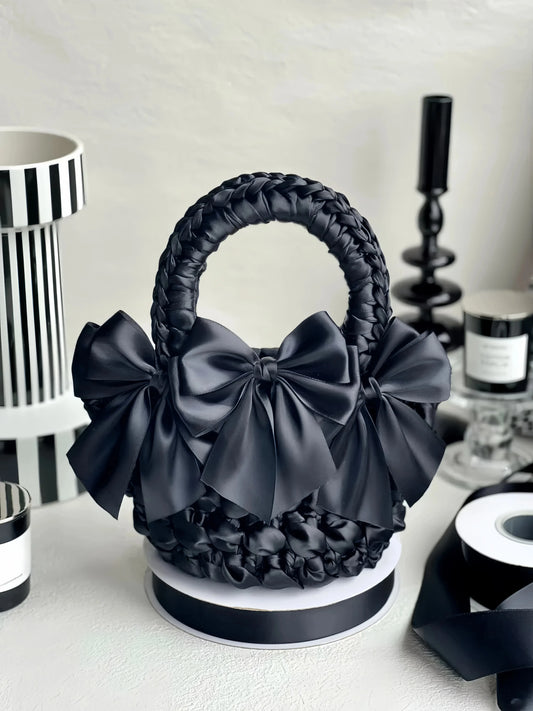 Crochet diagram for DIY bow adorned purse featuring detailed black braided handle and large satin bows