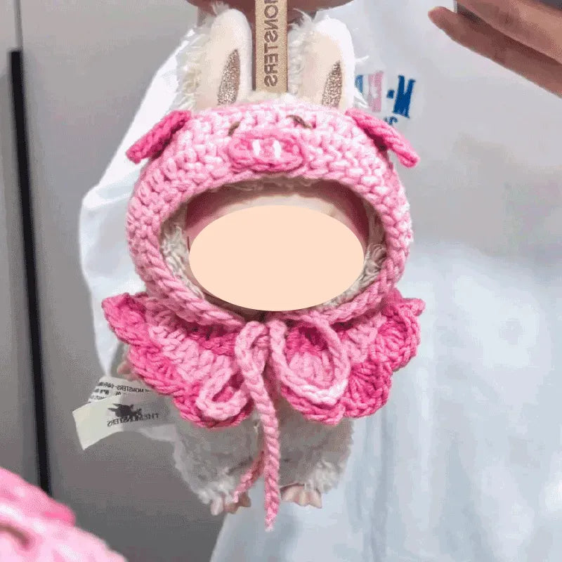 Handmade pink pig doll cape crochet pattern free displayed on a white stuffed animal by The Knit Krazy