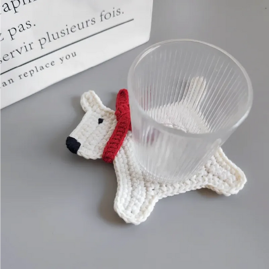 White crochet dog coaster with a red collar holding a clear glass demonstrating easy crochet patterns for beginners