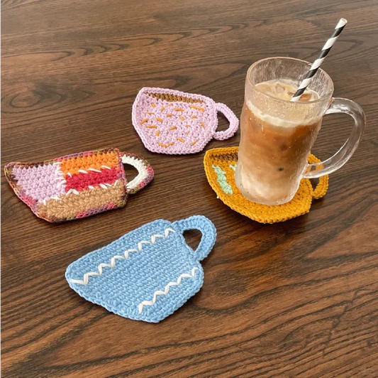 FREE|beginner crochet cup coaster set with colorful handmade cup-shaped designs on wooden table