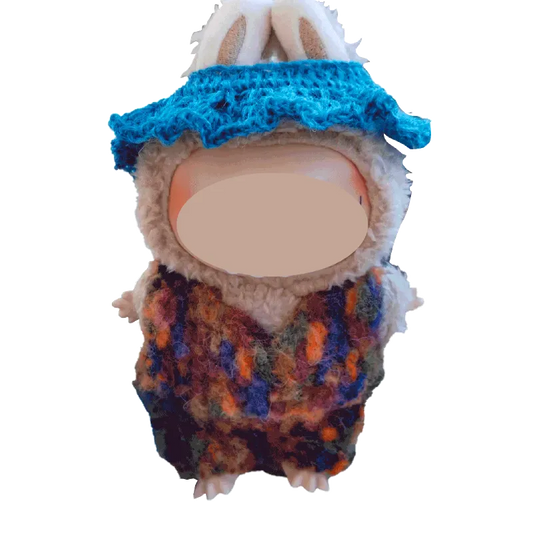 Plush doll wearing a colorful crochet collar and blue hat using FREE|crochet collar and hat pattern for plush dolls