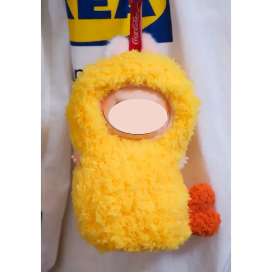 Yellow fluffy crochet fried shrimp plush with orange tail attached to white fabric background FREE|crochet fried shrimp plush pattern