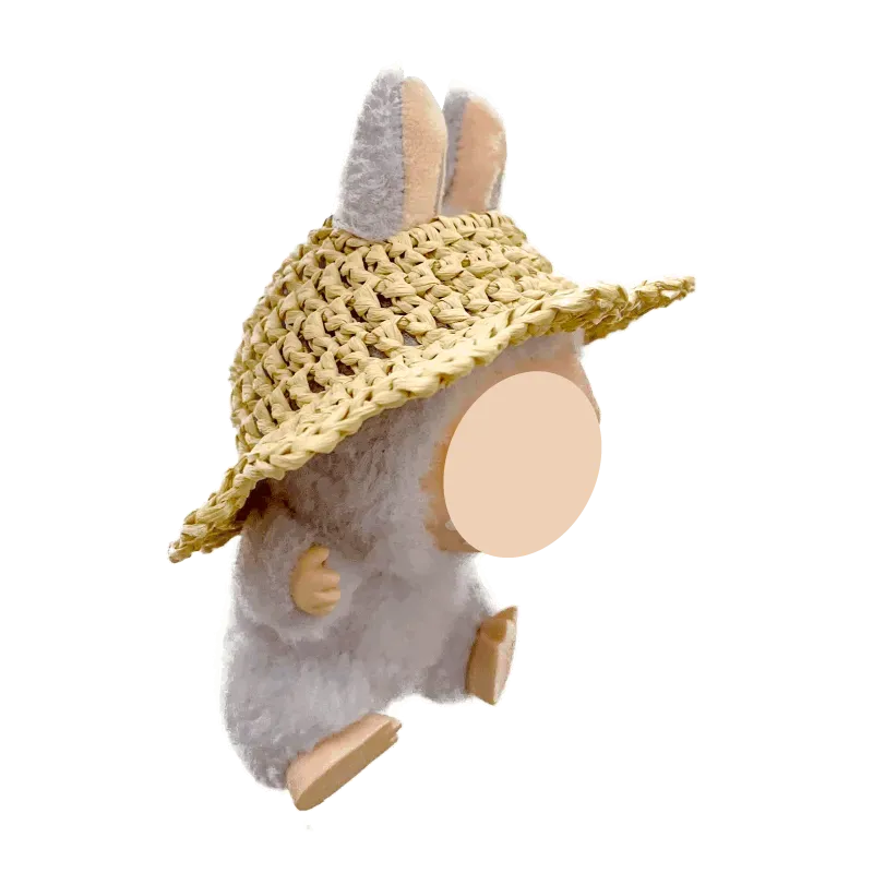 Plush bunny wearing a free crochet straw hat pattern with wide brim on black background