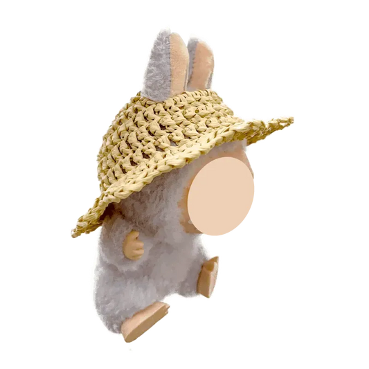 Plush bunny wearing a free crochet straw hat pattern with wide brim on black background