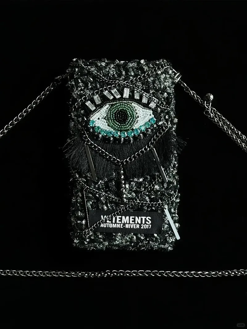 FREE|cyberpunk crochet phone bag pattern featuring a detailed eye design with black chain strap