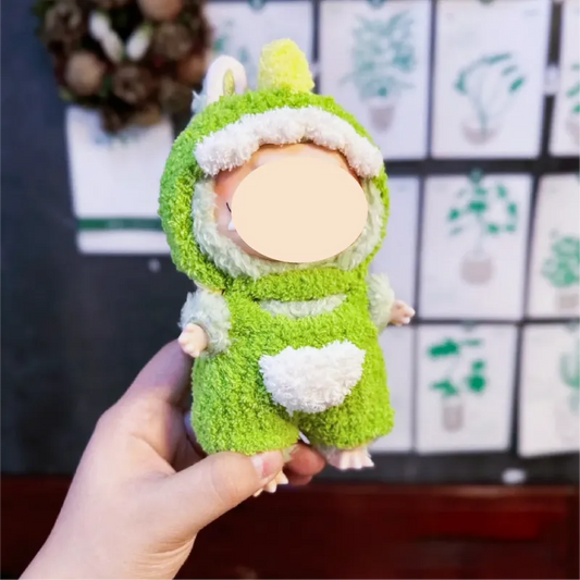 Hand holding a small doll dressed in a green and white crochet dinosaur costume free dinosaur crochet pattern