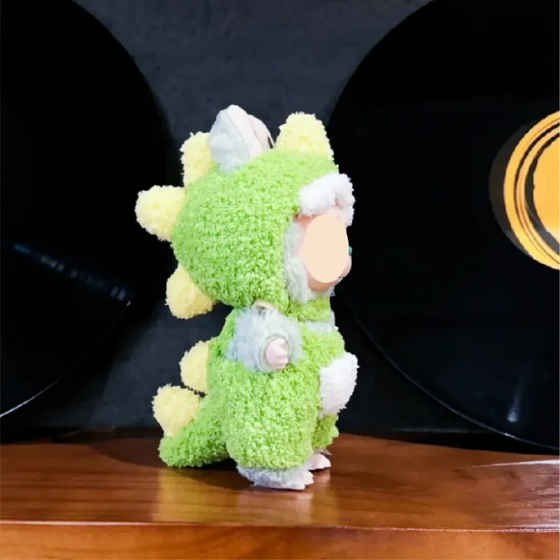 Cute plush toy wearing a green dinosaur costume showcasing free dinosaur crochet pattern design