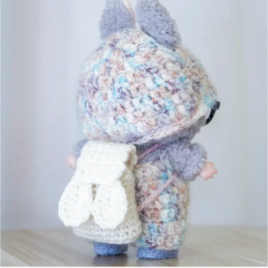 Crochet amigurumi doll wearing colorful outfit and white bunny backpack free doll accessories crochet pattern