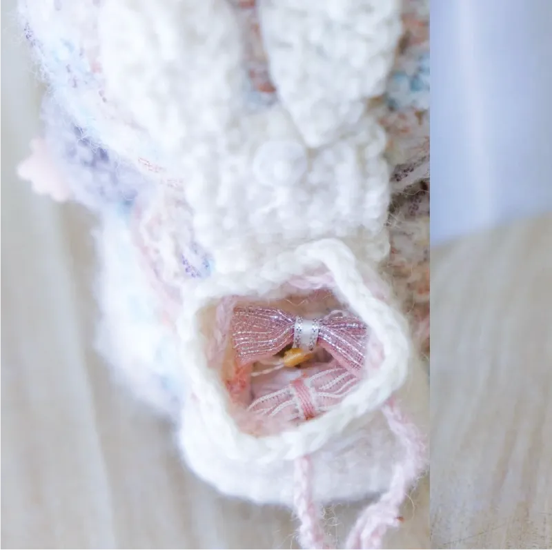 Close-up of white crochet doll shoe with pink bow showing free doll accessories crochet pattern