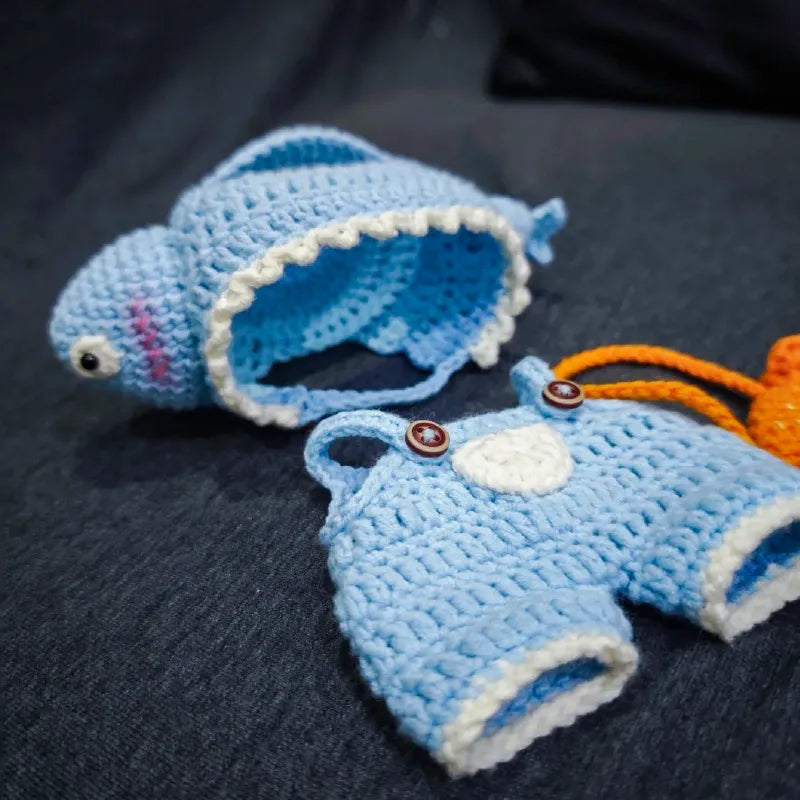Funny fish crochet doll outfit pattern featuring a blue fish hat and matching overalls with button straps