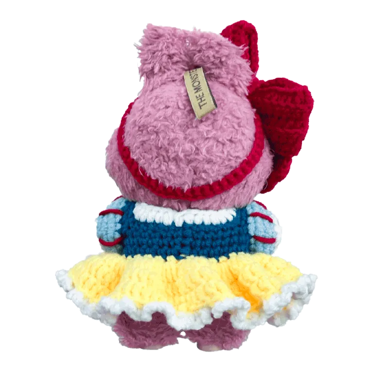 Back view of a handmade pink plush doll wearing a crocheted dress from 17cm collectible doll clothes pattern